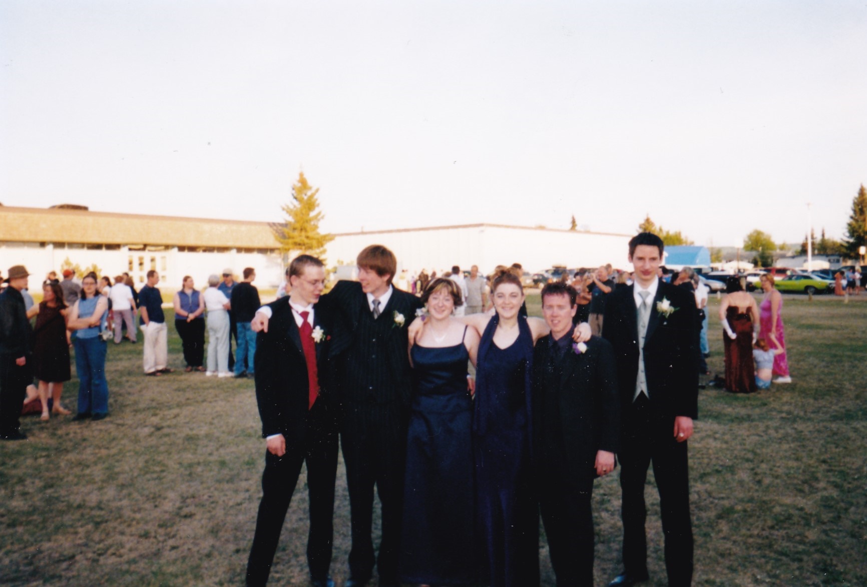 Graduation photographer a distant shot of me and my group of friends at the highschool before the grad banquet