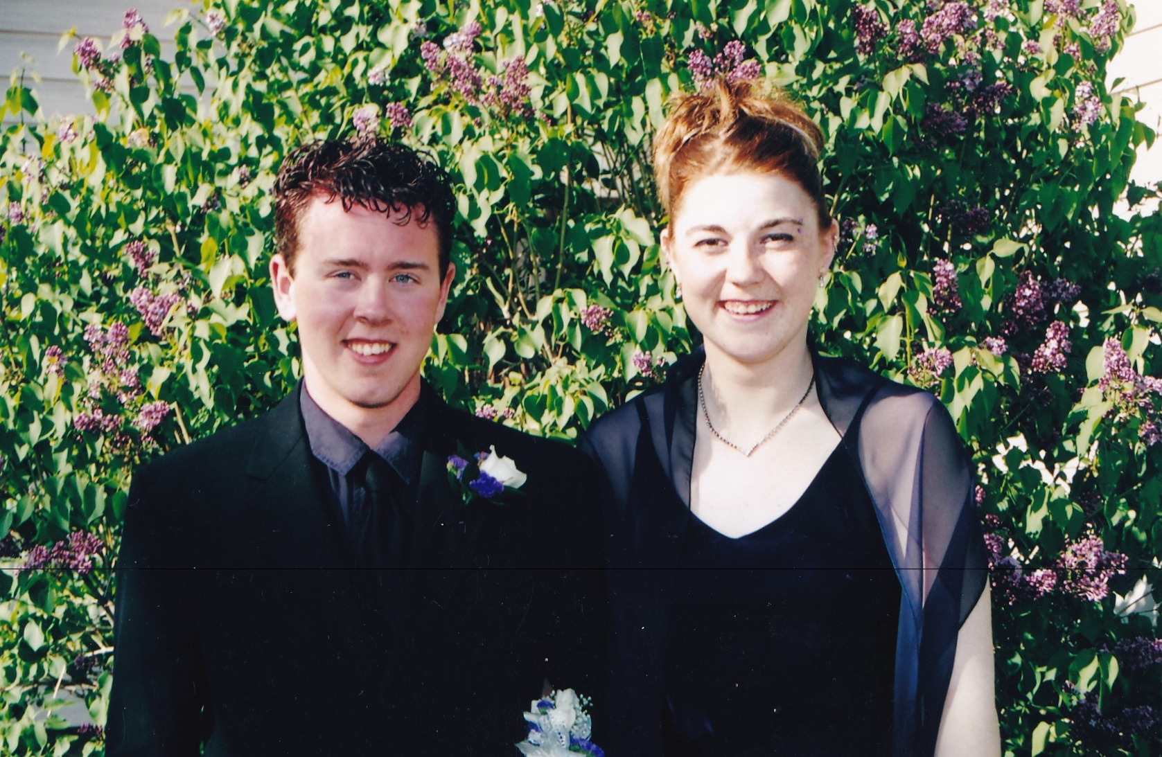 Graduation photographer a waist up shot of me and my date on prom day. Purple was our color but the purple is lost in the difficult exposure