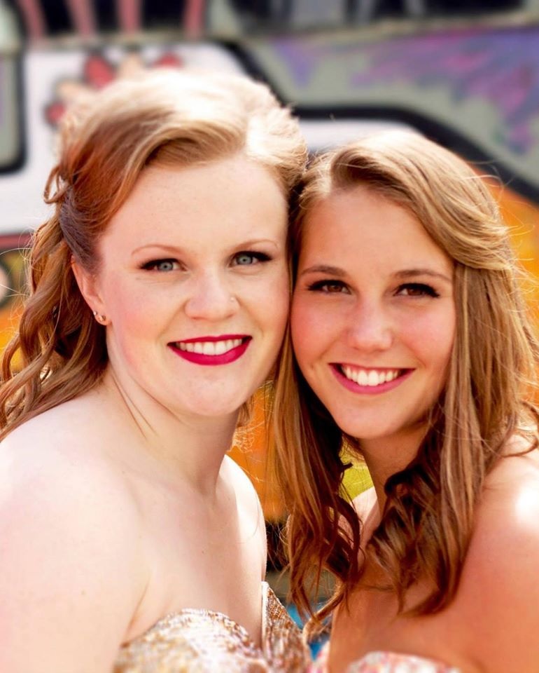 Prom Photographer two female graduates pose cheek to cheek, smiling at the camera.